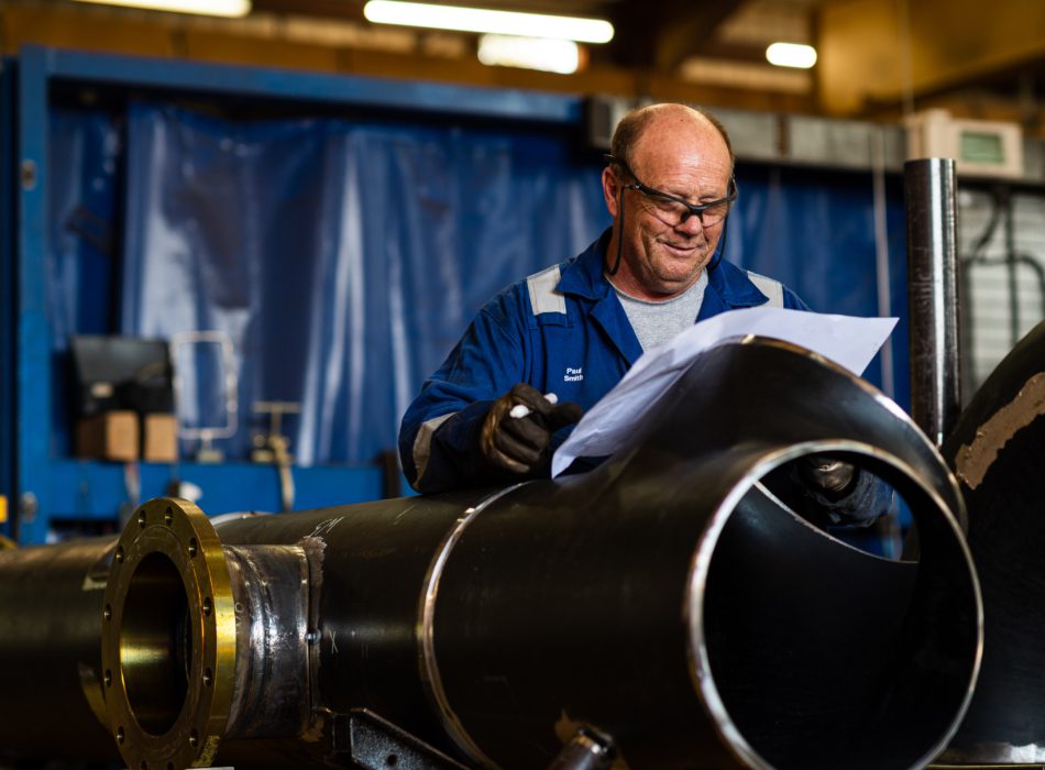 Puma Engineer with pipe blueprints