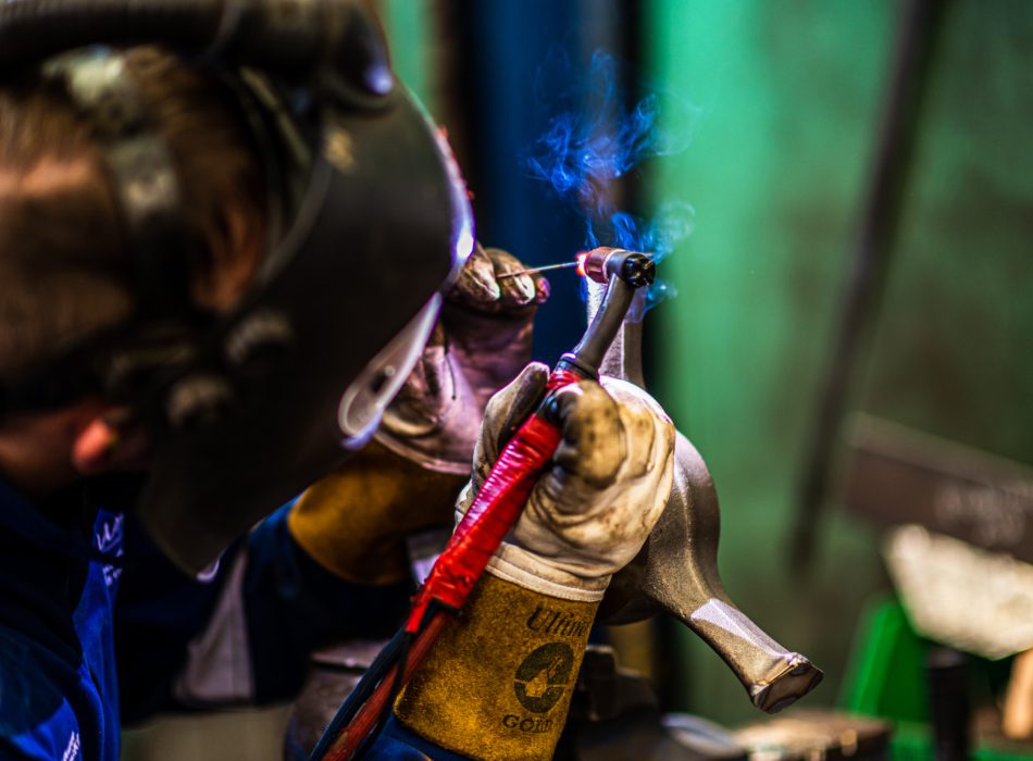 A Puma engineer welds a wire